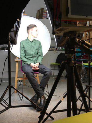 Collodion photography: Here's a subject, under bright lights, surrounded by some of the necessary paraphernalia
