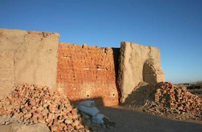 Here is a packed brick kiln. The red colour means that these bricks have been fired. The clay walls of the kiln, buttressed by bricks, are used and re-used