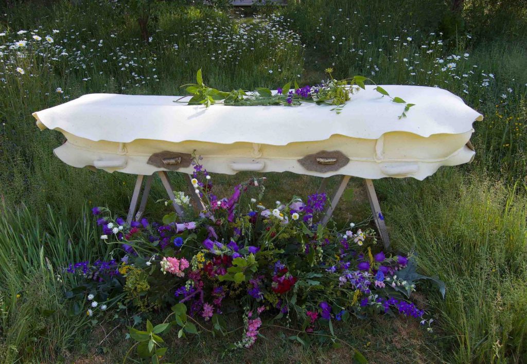 A felt cocoon - much more gentle than a coffin. laid out in a country setting with some lovely flowers. Contact https://bellacouche.com/
